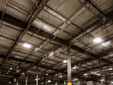 Dark warehouse interior with exposed unfinished roof framing